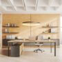 Wooden office interior with work desk and laptop, panoramic window