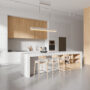 Stylish home kitchen interior with bar counter and shelves with kitchenware